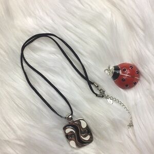 Lia Sophia, 1 1/2 x 1 3/8, leather cord, 22”, EUC.